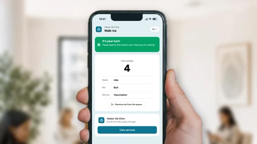 Customer ticket with queue number and estimated wait next to the staff queue screen